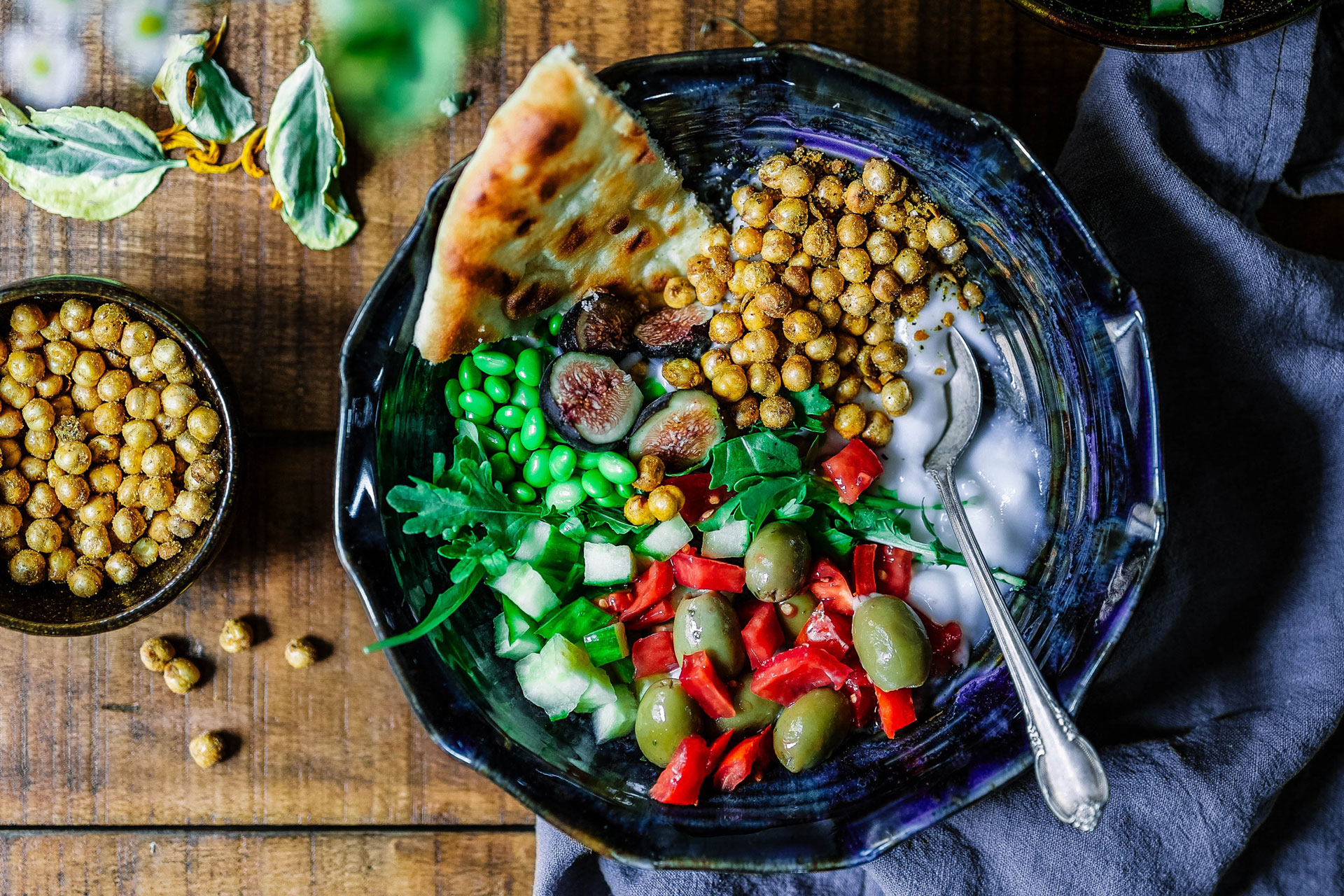 Beans, herbs, olives, yogurt in bowl