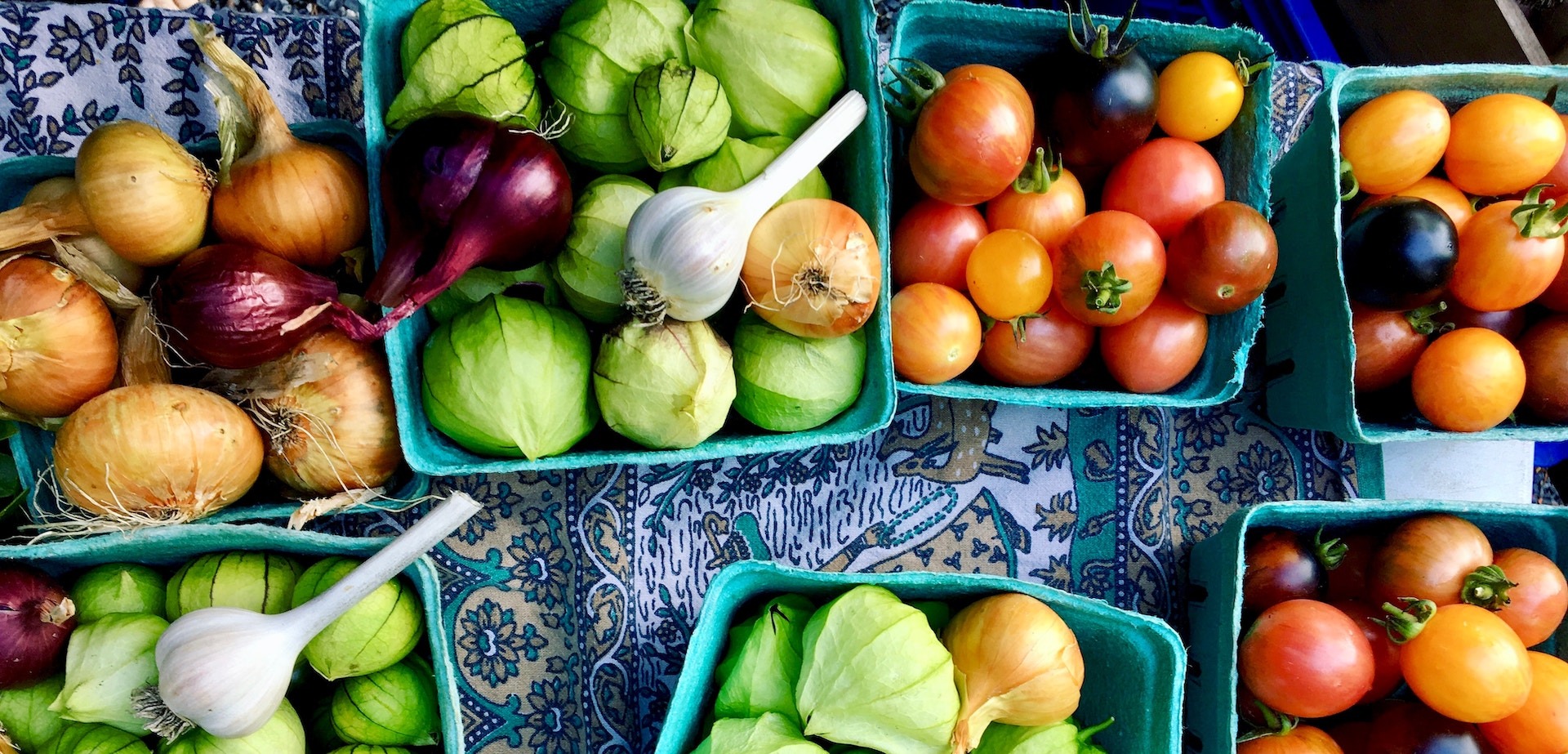 garlic tomatoes and tomatillos on farmers market table